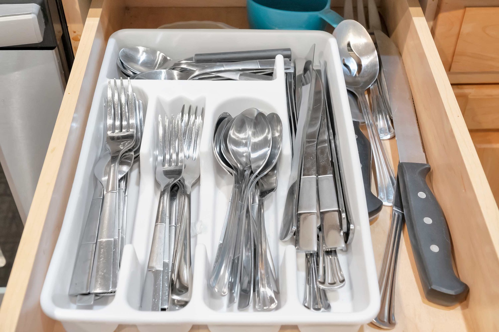 Your kitchen is fully stocked with everything you need—gleaming cutlery and utensils ready for preparing and enjoying home-cooked meals during your stay.