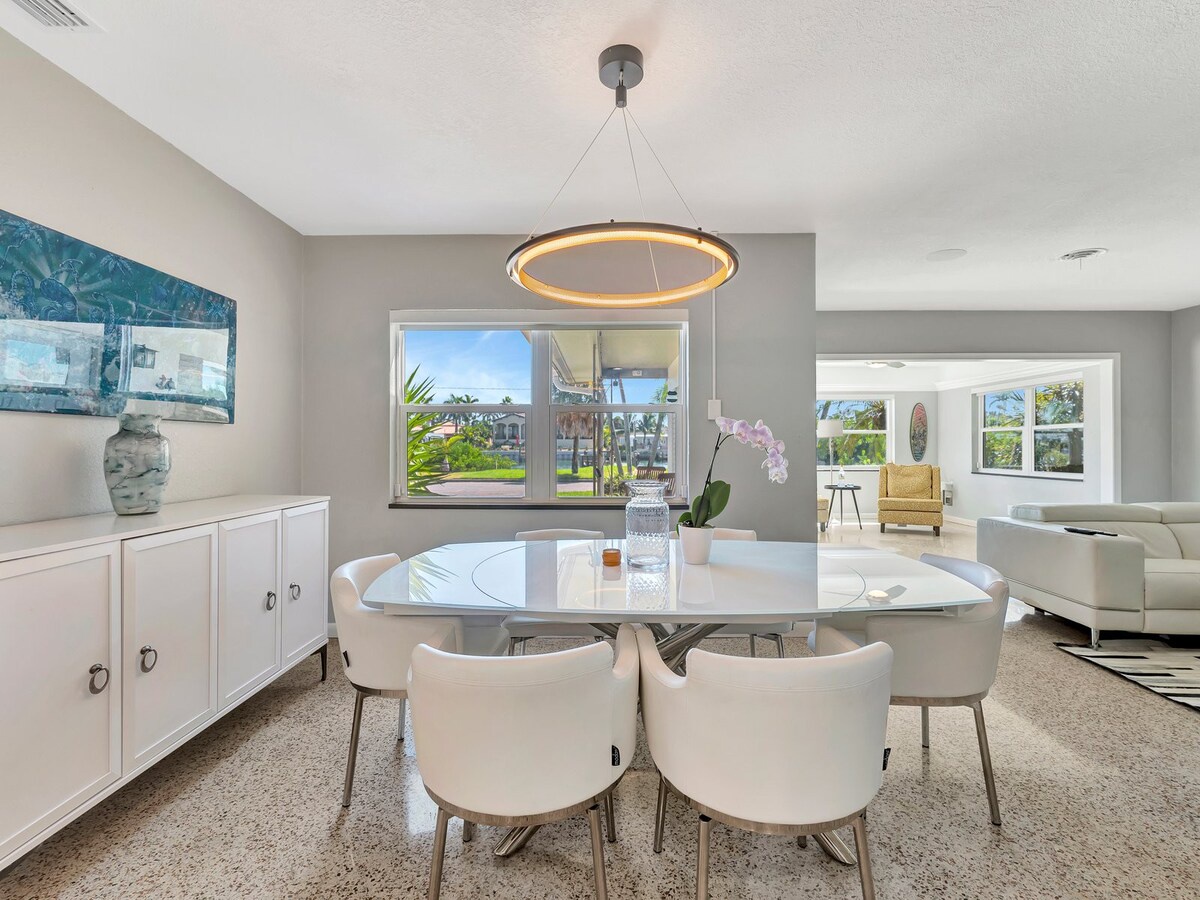 Gather around this elegant dining area where your group can share meals under a modern chandelier. Fresh orchids set a welcoming tone, and the open layout flows seamlessly into your comfortable living space.