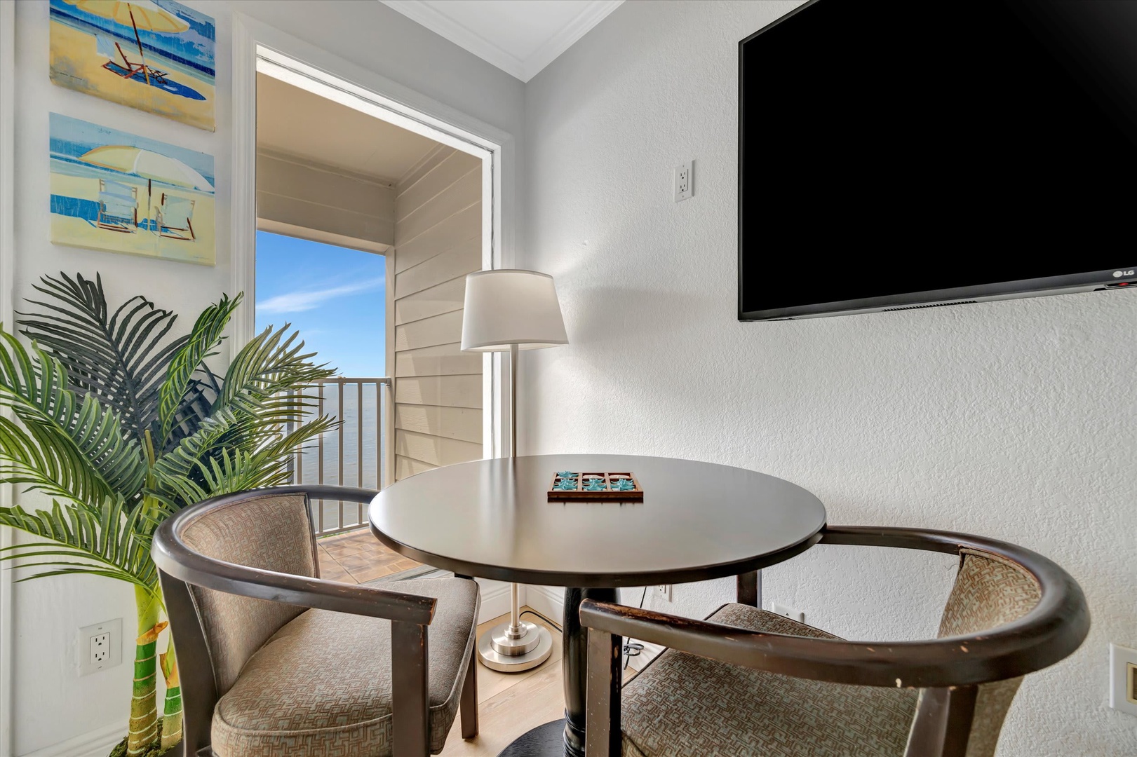 Step outside through open doors and settle into your private seating area, where soft breezes and quiet coastal views create the perfect backdrop for morning coffee or evening conversation.