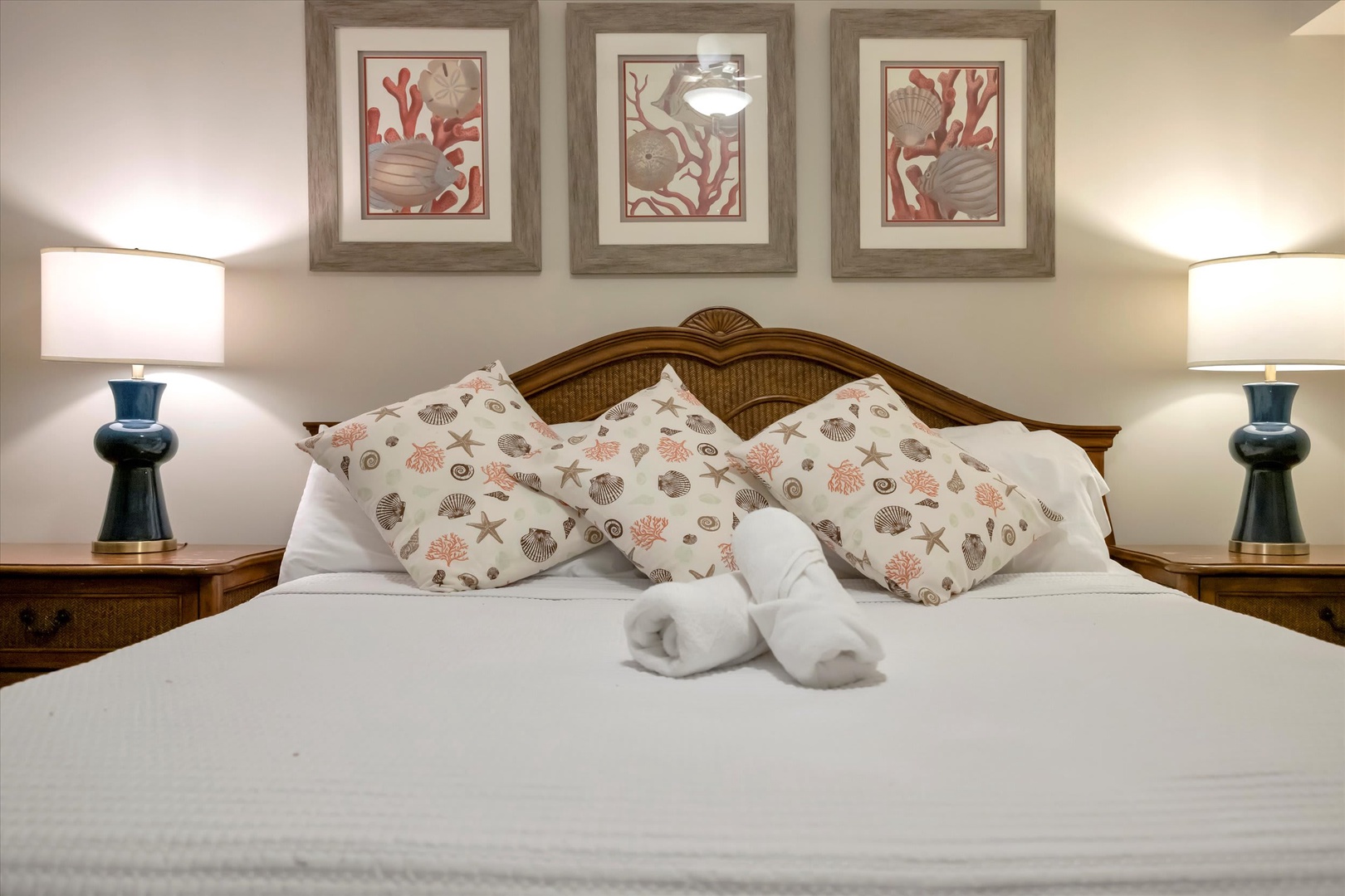 Sink into plush comfort with coastal-themed pillows and crisp linens, where thoughtful touches like rolled towels await your arrival.