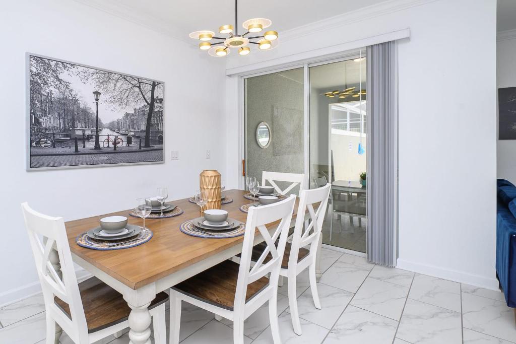 Gather around your beautiful dining table for meals and conversation, with a cozy atmosphere enhanced by modern lighting and easy access to the outdoor space.
