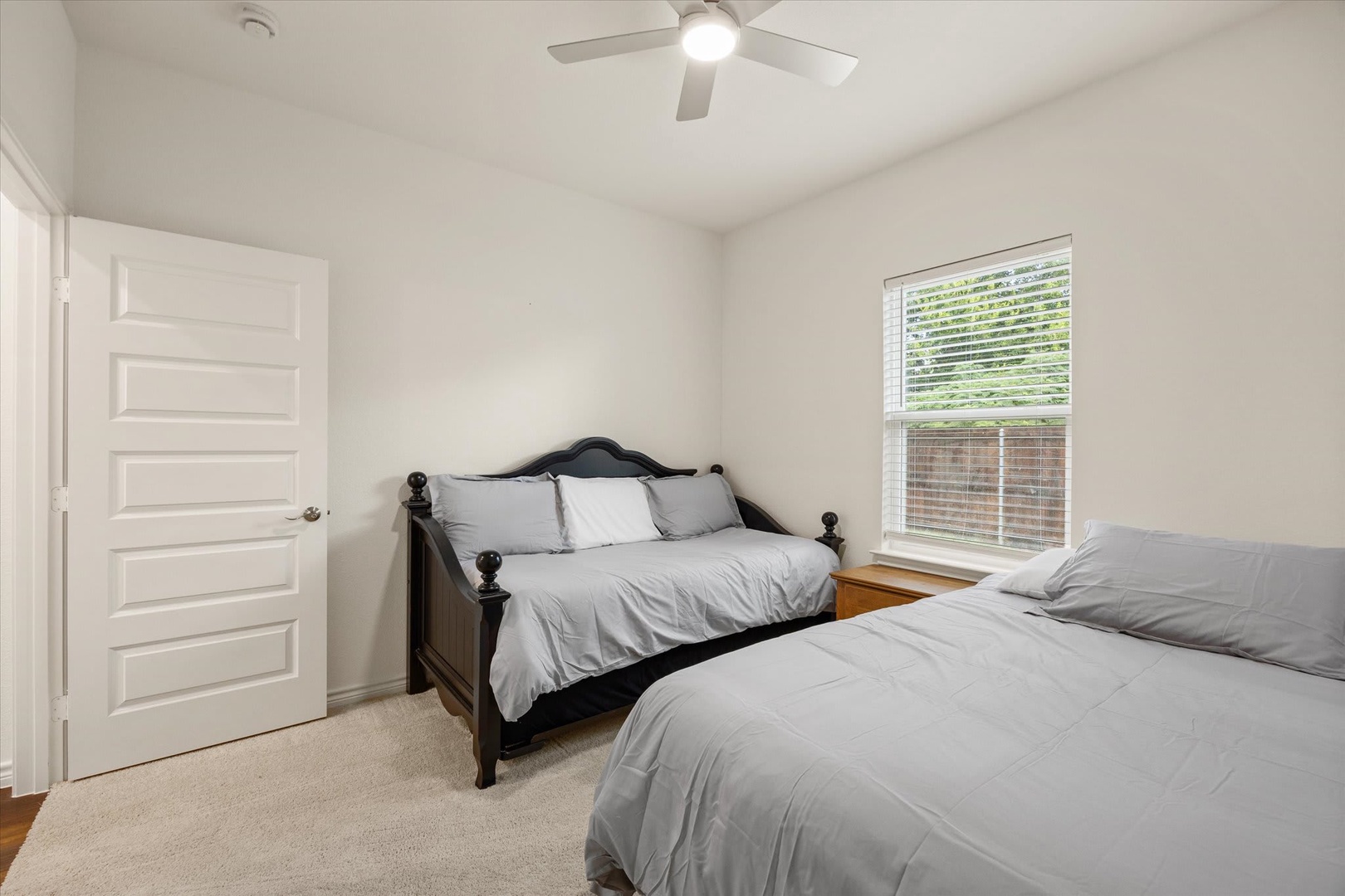 Unwind in your peaceful bedroom, where soft linens and gentle breezes from the ceiling fan create the perfect retreat after a day of adventure. Two comfortable beds await to lull you into a restful night's sleep.