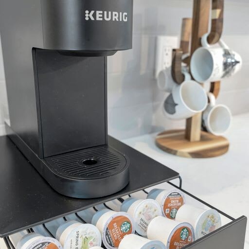 Brew your perfect morning cup with this sleek Keurig coffee maker, complete with a handy K-cup drawer to keep your favorite flavors close at hand.