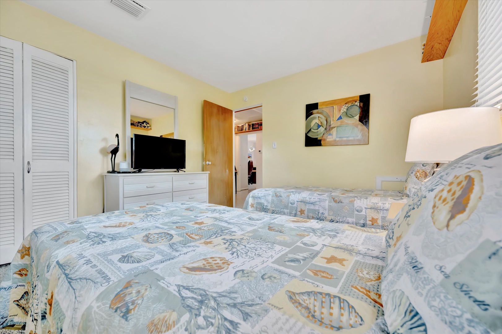 Sink into soft coastal bedding and wake to gentle ocean-themed decor. Your peaceful retreat includes all the essentials—TV, closet storage, and cool air conditioning for comfort.