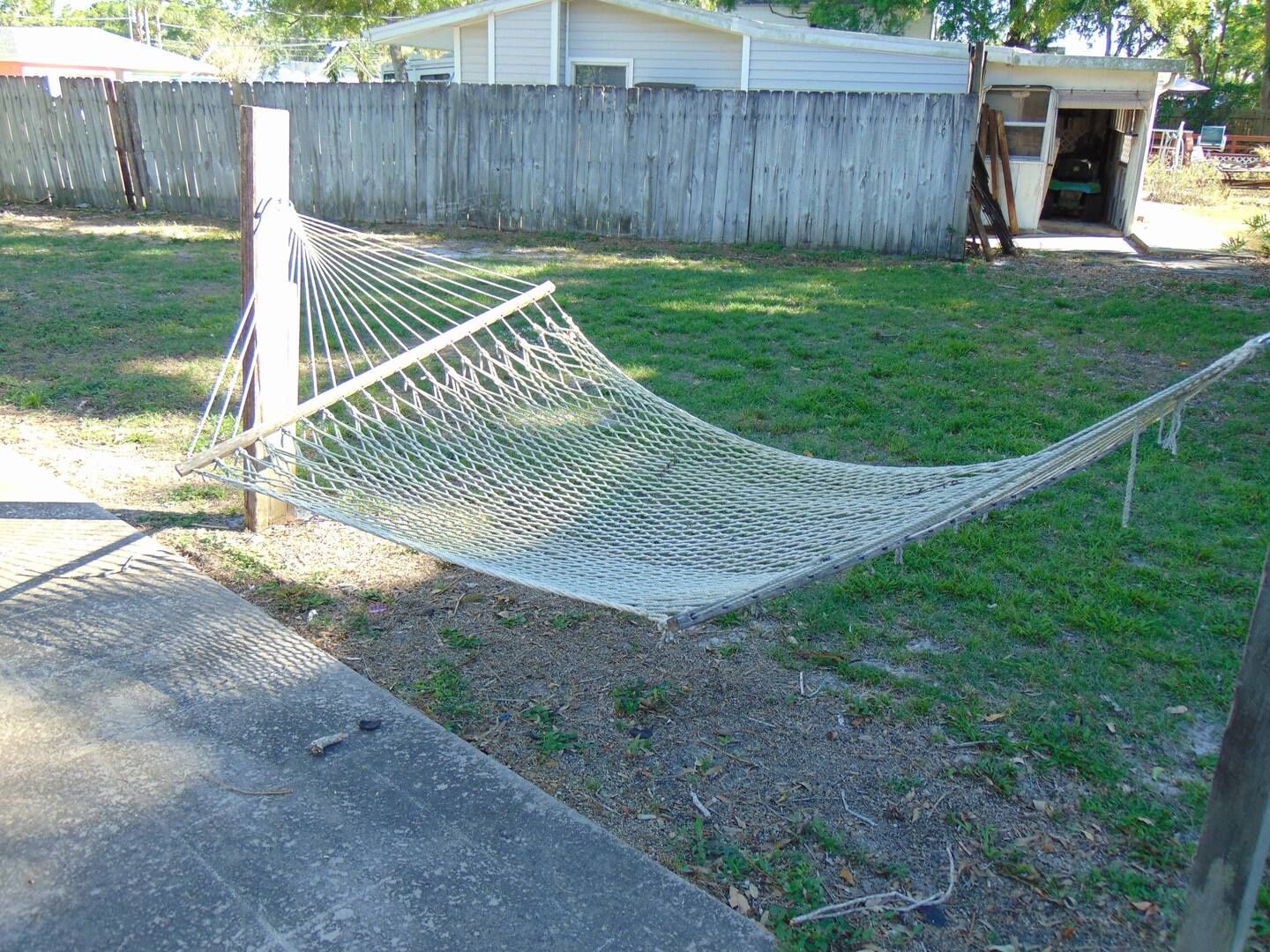Swing gently in your private hammock, surrounded by a spacious lawn perfect for relaxing afternoons under dappled sunlight.