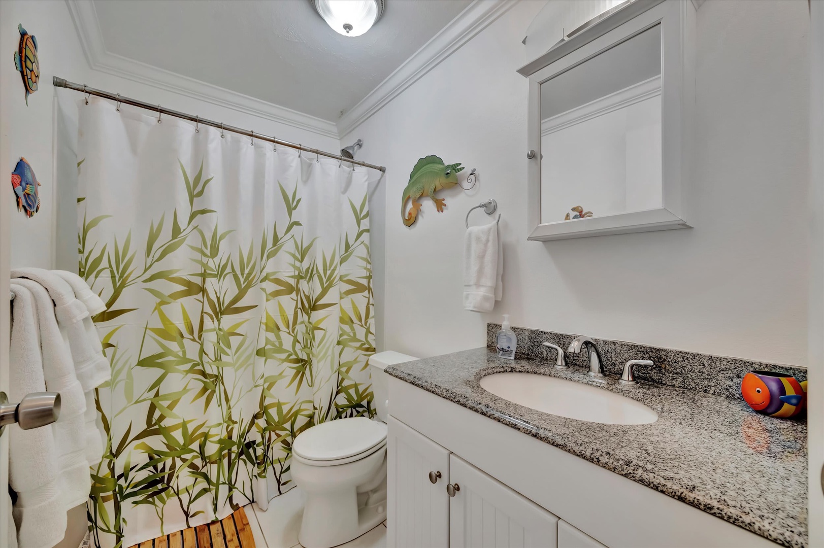 Step into your private bathroom where fresh towels await and playful touches make you smile—perfect for freshening up after a day of adventure.