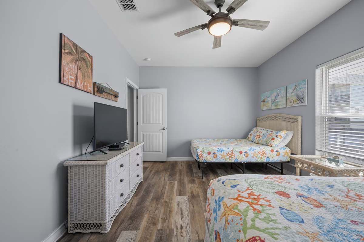 Drift off to sleep in this cheerful, coastal-themed bedroom with comfortable twin beds and beachy decor that makes every night feel like a seaside escape.