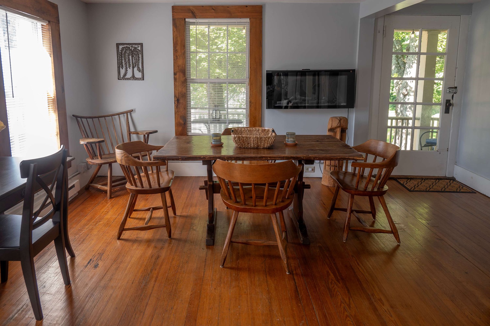 Gather around this warm wooden table, where you'll share meals and stories with your favorite people. Natural light spills through the windows, creating the perfect setting for morning coffee or evening dinners.