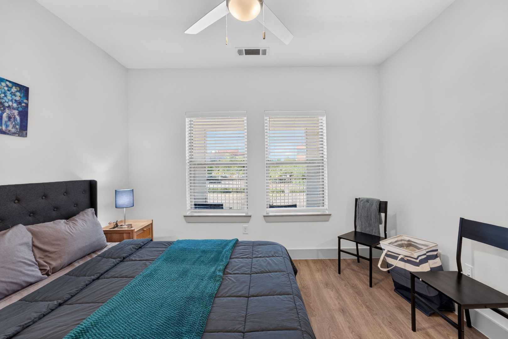 Your peaceful bedroom retreat features vaulted ceilings and bright natural light streaming through plantation shutters, creating the perfect space to unwind after a day of adventure.
