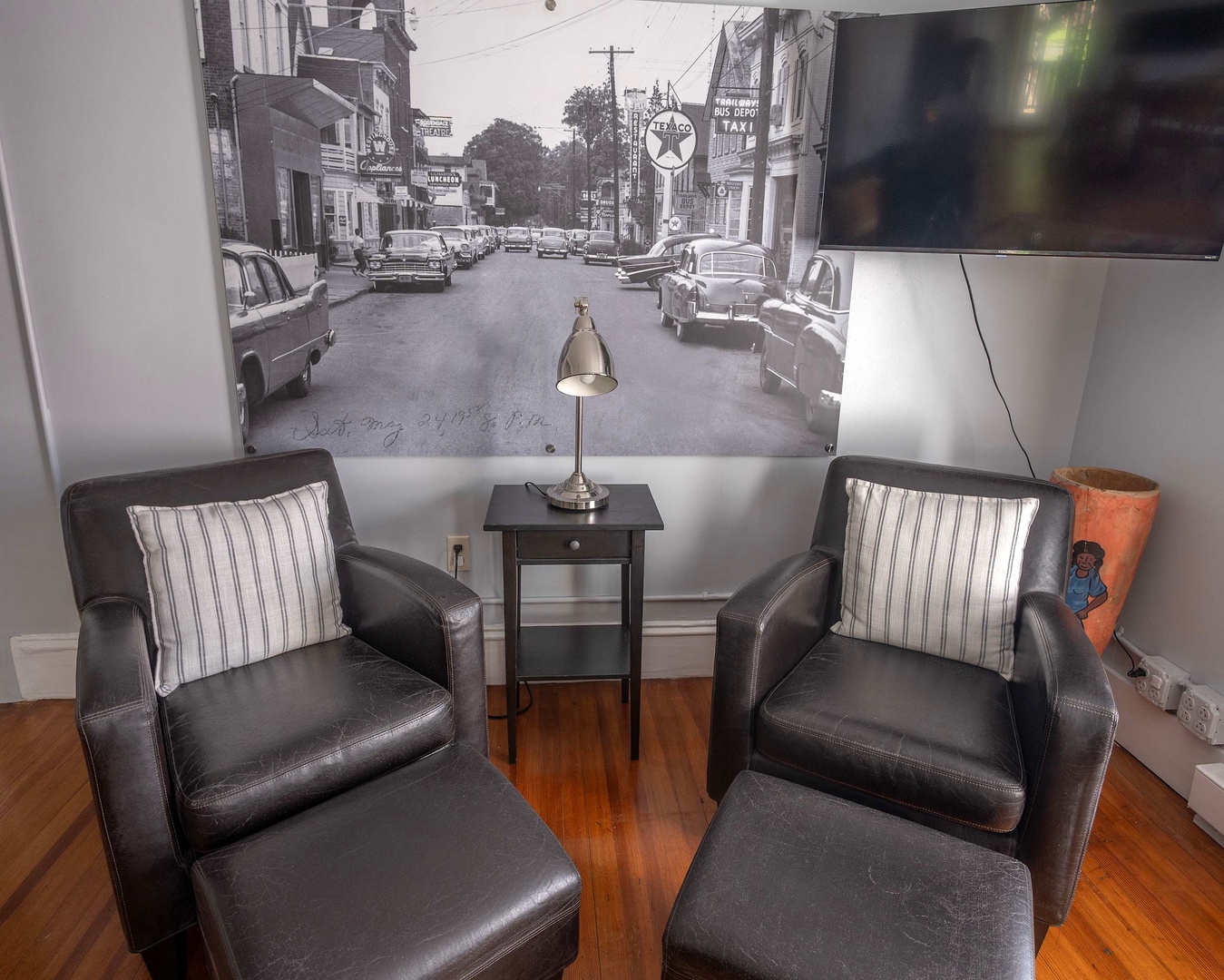 Unwind in your cozy seating nook with a vintage street mural that adds character and charm to your stay.