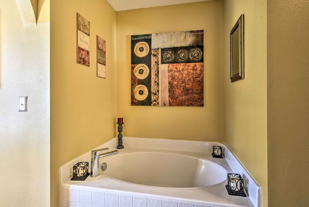 Sink into this inviting corner tub and let your worries melt away in a space designed for ultimate relaxation.