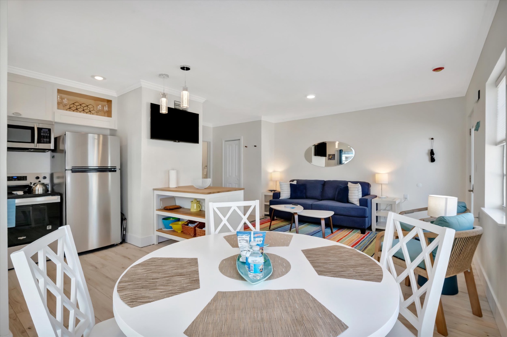 Step into your open-concept retreat where modern comfort meets coastal charm. Cook, dine, and unwind in a sunlit space designed for effortless vacation living.