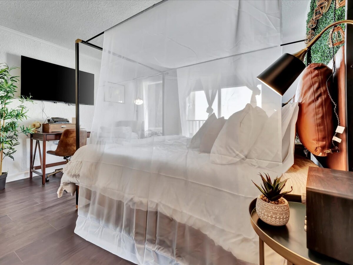 Drift into dreamy sleep under your billowing canopy bed, where soft linens and stylish touches create your peaceful retreat.
