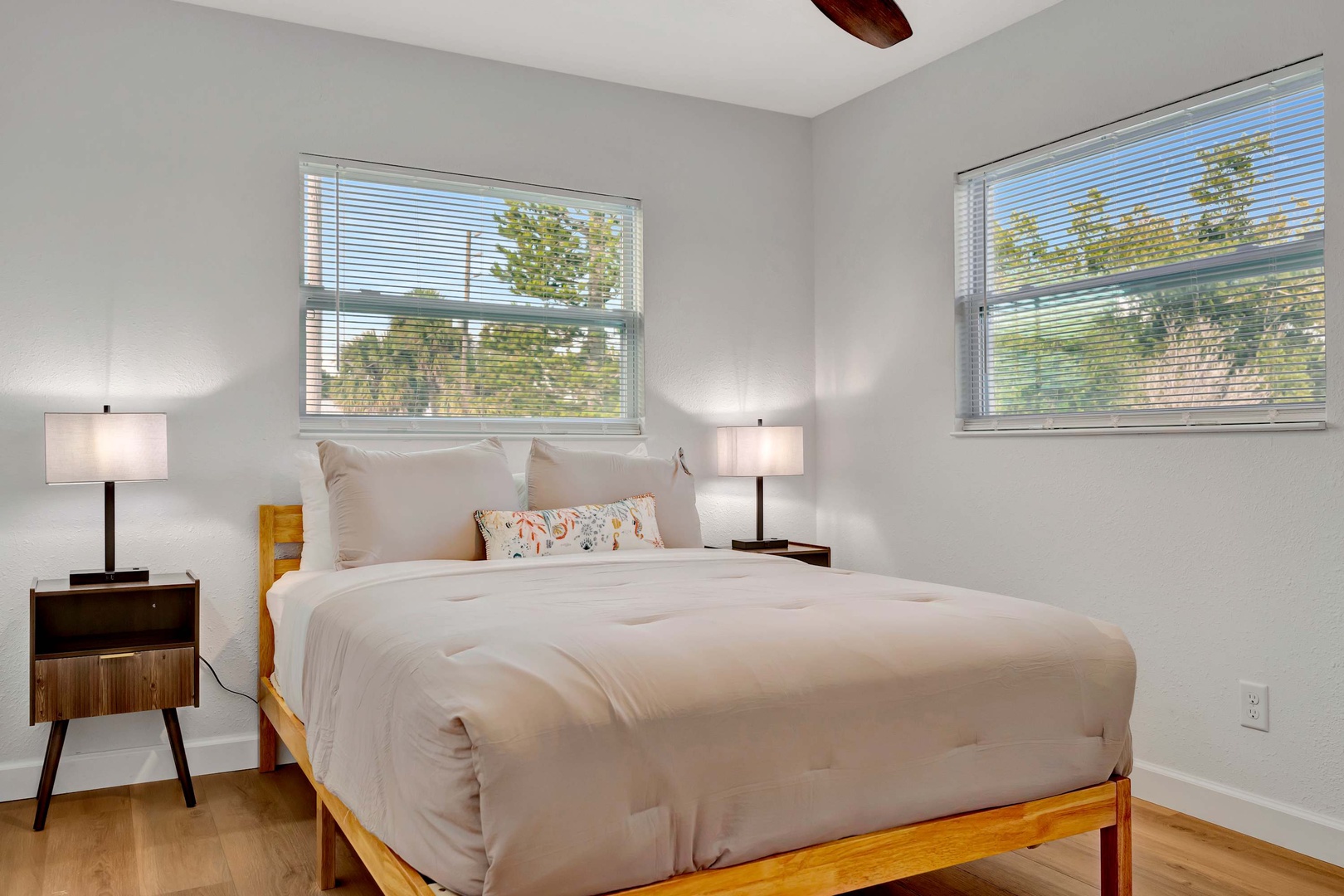 Rest easy in this peaceful bedroom where natural light and fresh breezes invite a good night's sleep. Climb into your cozy bed and drift off to the rhythm of the outdoors.