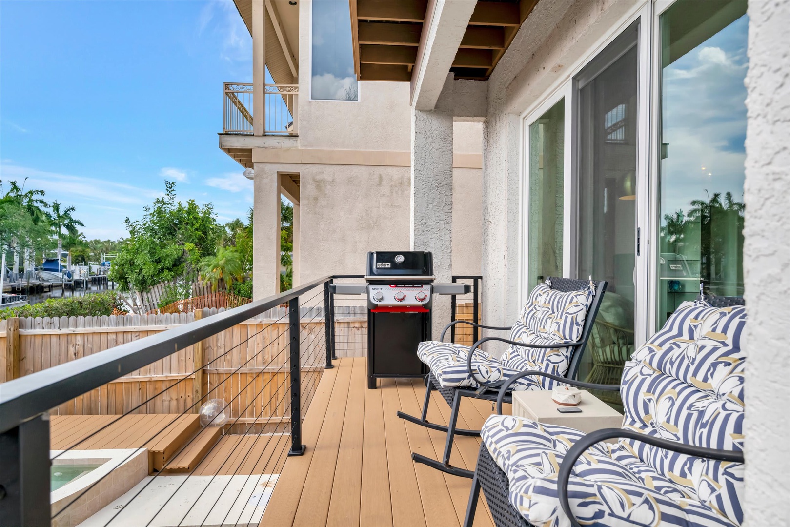 Settle into your private balcony with comfortable seating and a gas grill—perfect for unwinding with morning coffee or sizzling up fresh catches as palm trees sway in the breeze.