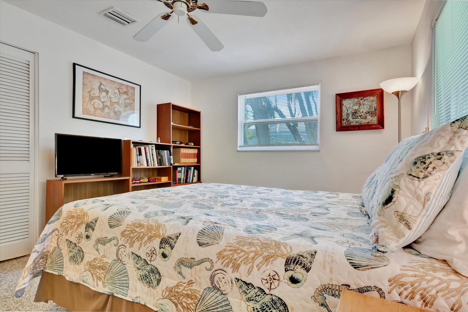 Settle into your comfortable bedroom where soft tropical breezes from the ceiling fan meet coastal charm. Natural light, smart storage, and your own entertainment center make this space feel like home.