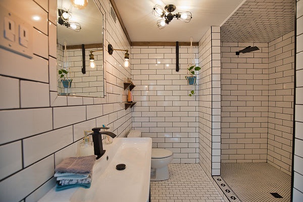 Step into your beautifully tiled sanctuary, where subway-style walls and warm lighting create a spa-like retreat. The walk-in shower and modern fixtures offer a refreshing escape after your adventures.