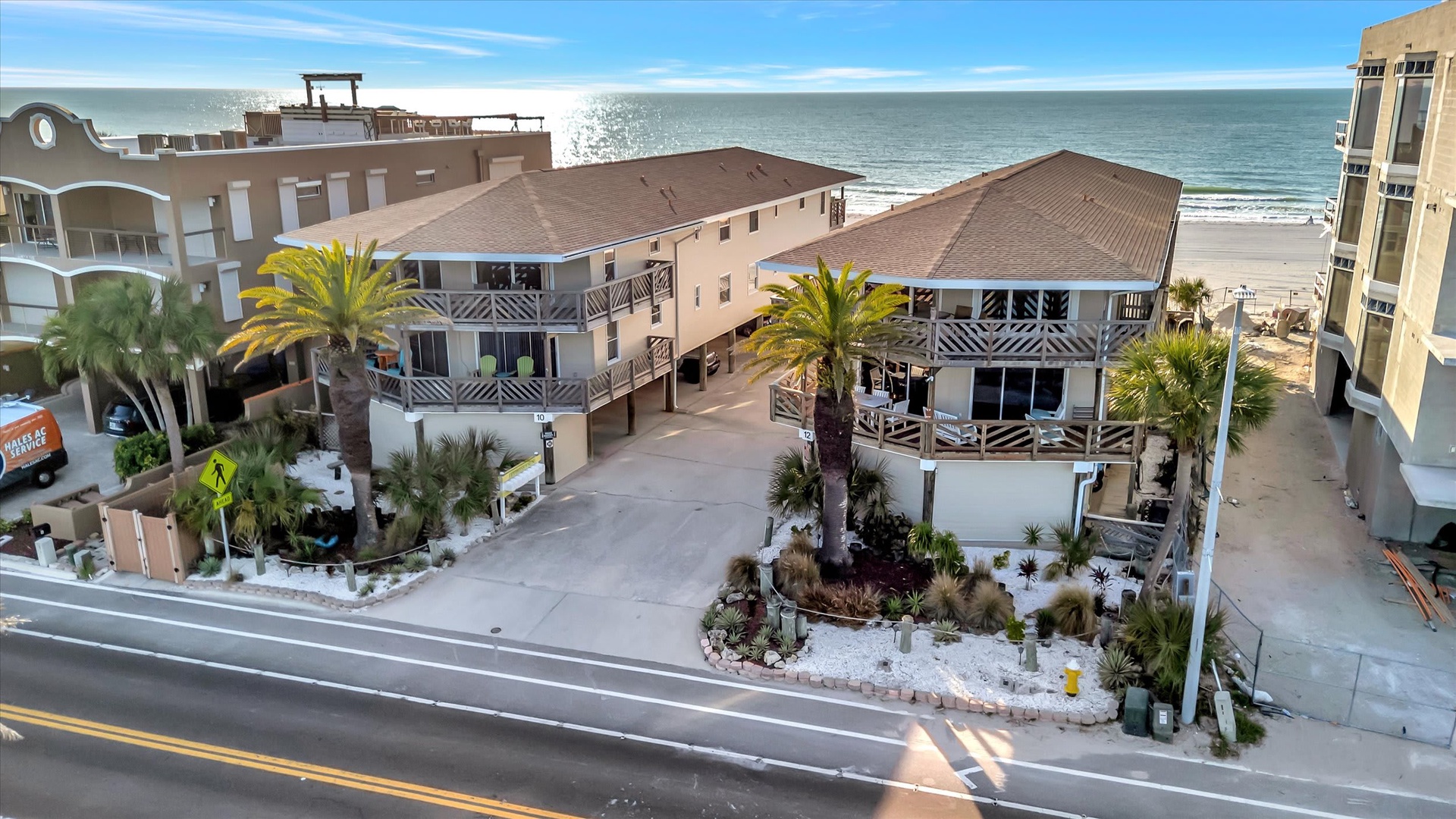 Beachfront property featuring multilevel architecture with tropical landscaping and direct ocean access, located just steps from the sandy shore.