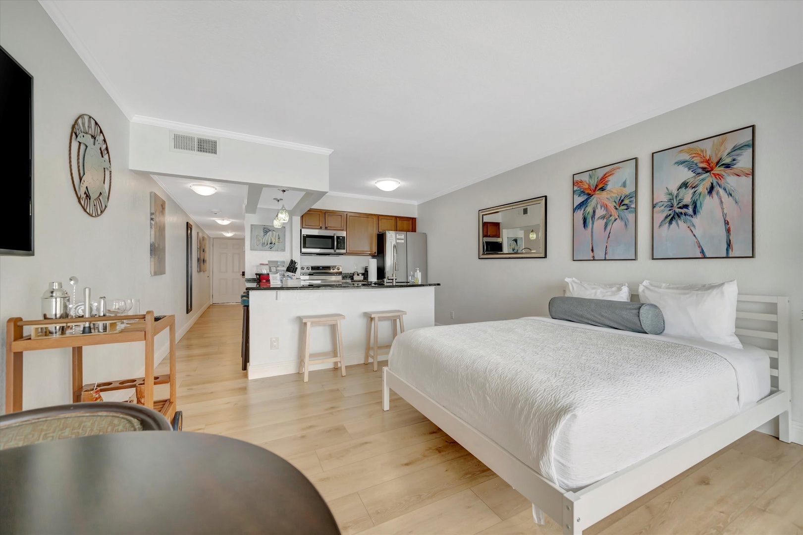 Settle into your bright, open studio where modern comfort meets coastal charm. Light wood floors and a crisp white palette create a serene space that flows effortlessly from your plush bed to the fully equipped kitchen.