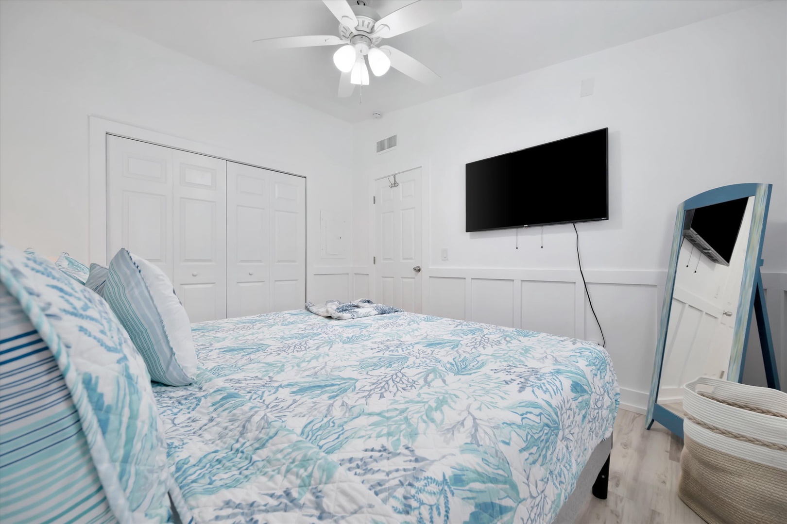 Drift off in your serene bedroom, where vaulted ceilings and gentle sea-themed linens create a peaceful coastal retreat for restful nights.