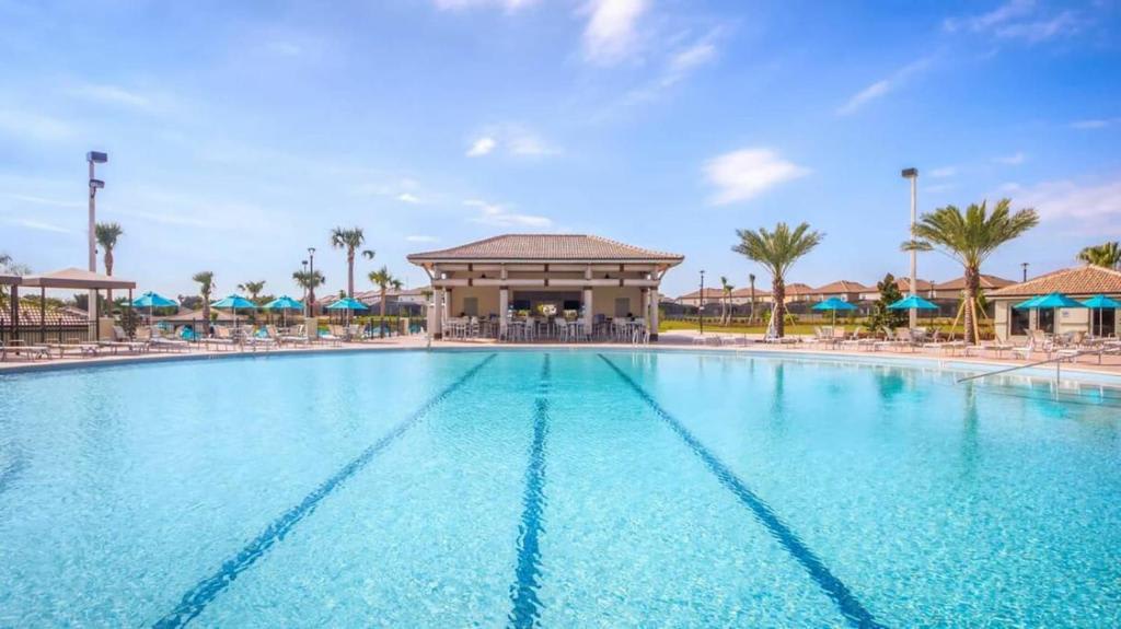 The resort-style pool complex features crystal-clear lap lanes, palm-lined decks with loungers and shade umbrellas, and a stylish covered pavilion for relaxing poolside moments.
