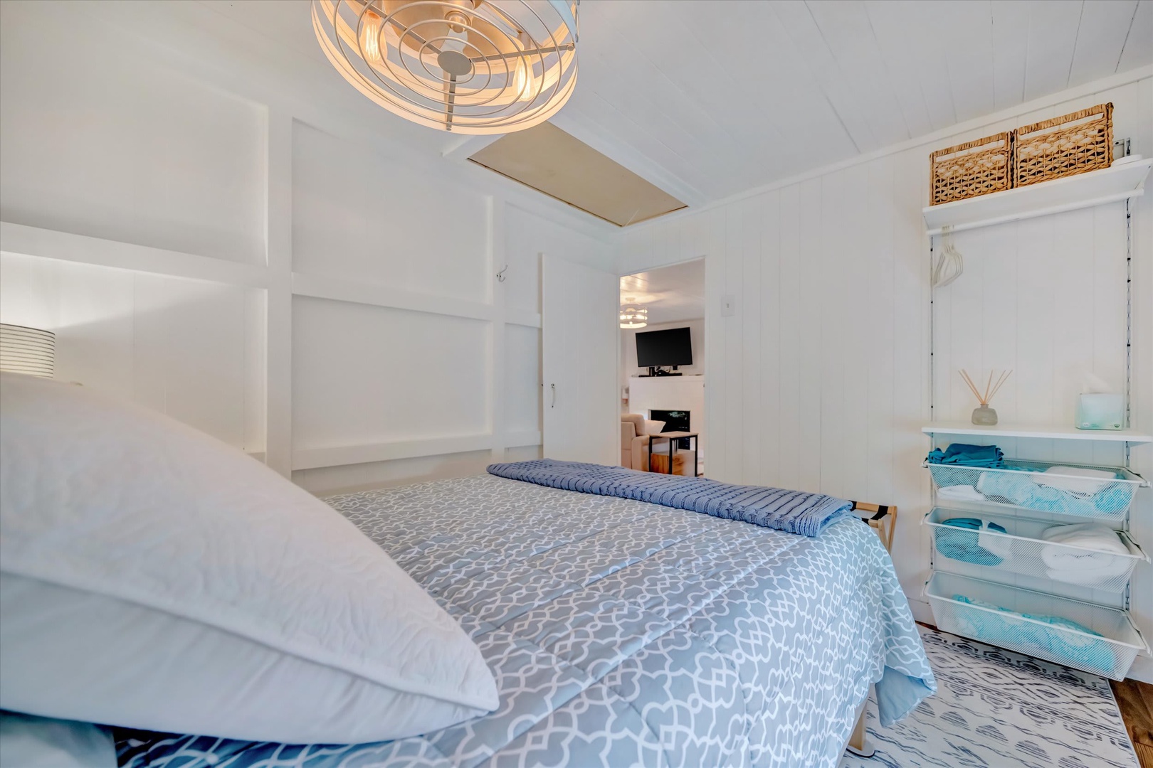 Relax in your bright, coastal-inspired bedroom with crisp linens, smart storage, and a stylish ceiling fan overhead—your personal retreat after a day of adventure.