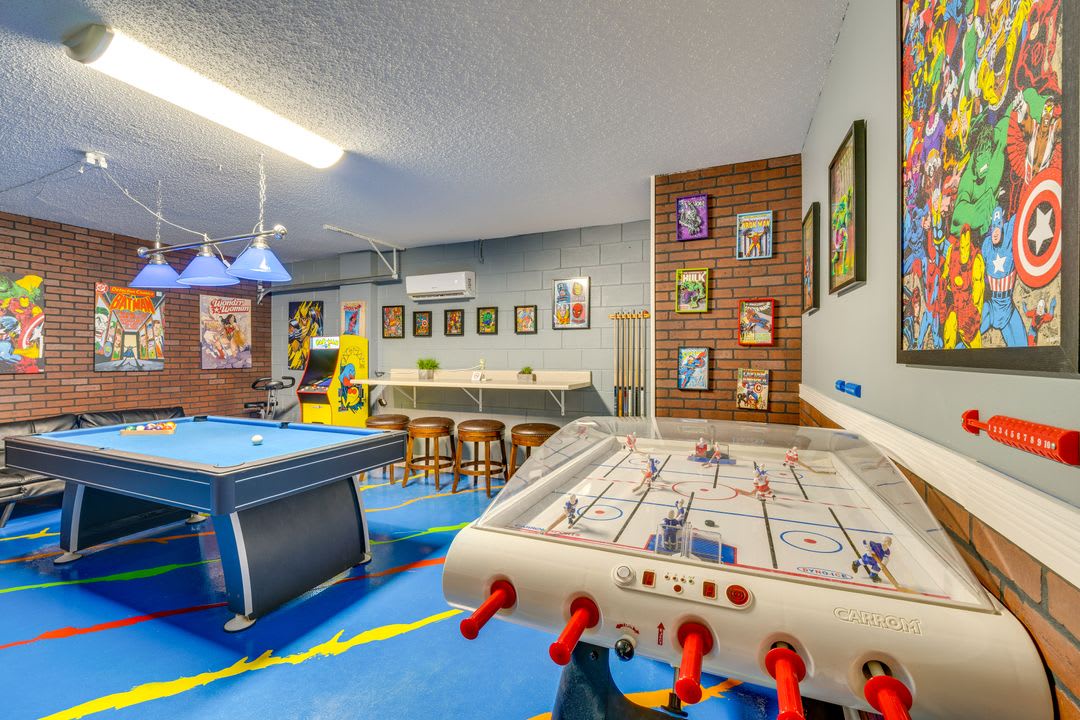 Your own private game room awaits, complete with pool table, air hockey, arcade games, and vibrant comic-book art adorning exposed brick walls—perfect for friendly competition and laid-back fun.