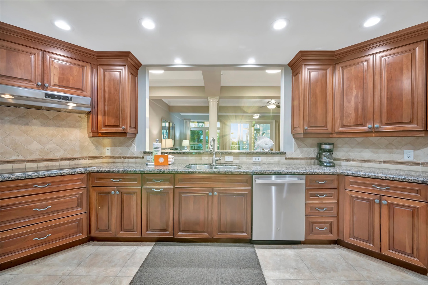 Your gourmet kitchen features warm wood cabinetry, granite countertops, and stainless steel appliances with ample prep space for preparing memorable vacation meals.