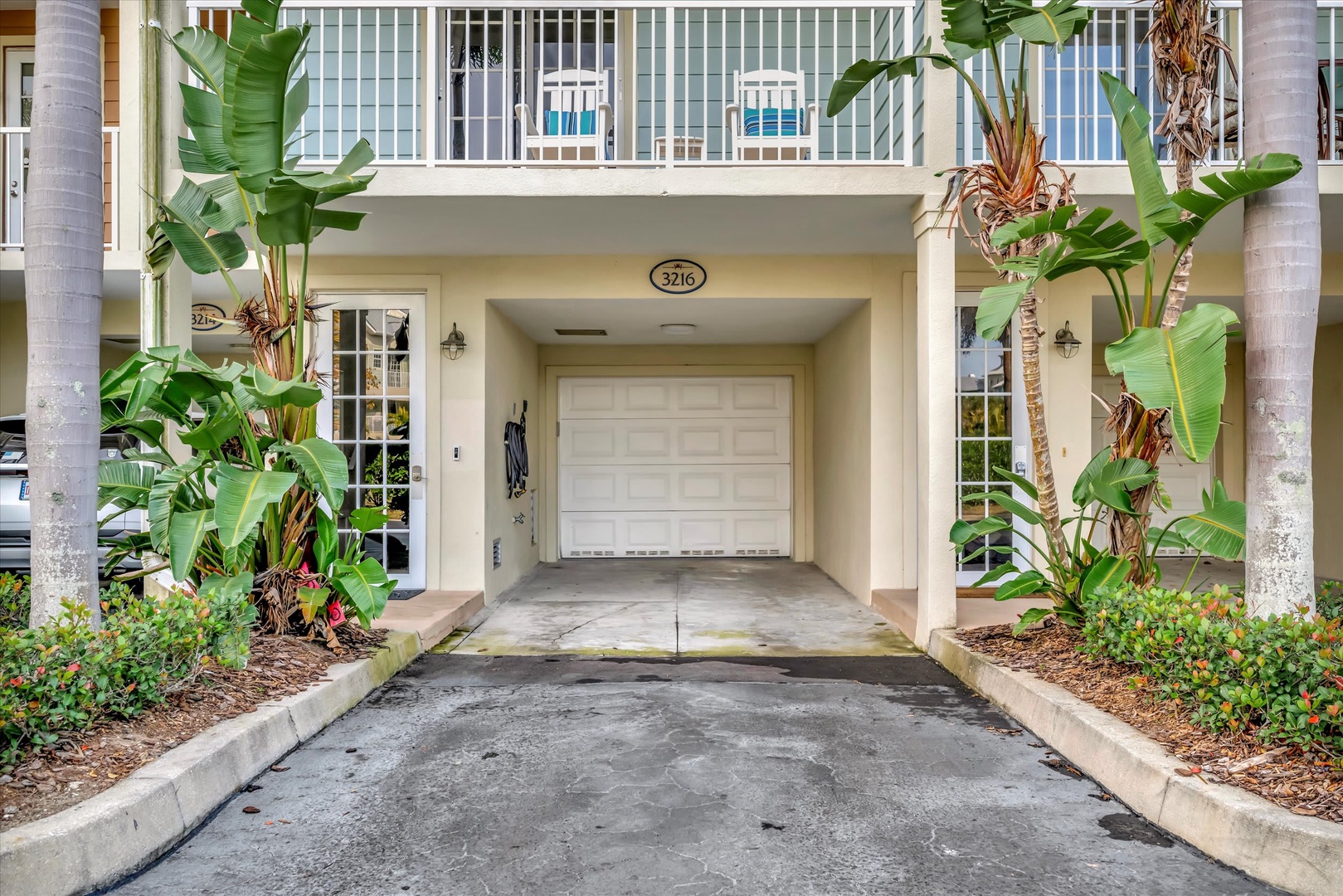 The property entrance features covered parking and tropical landscaping, creating an inviting arrival experience at unit 3216.