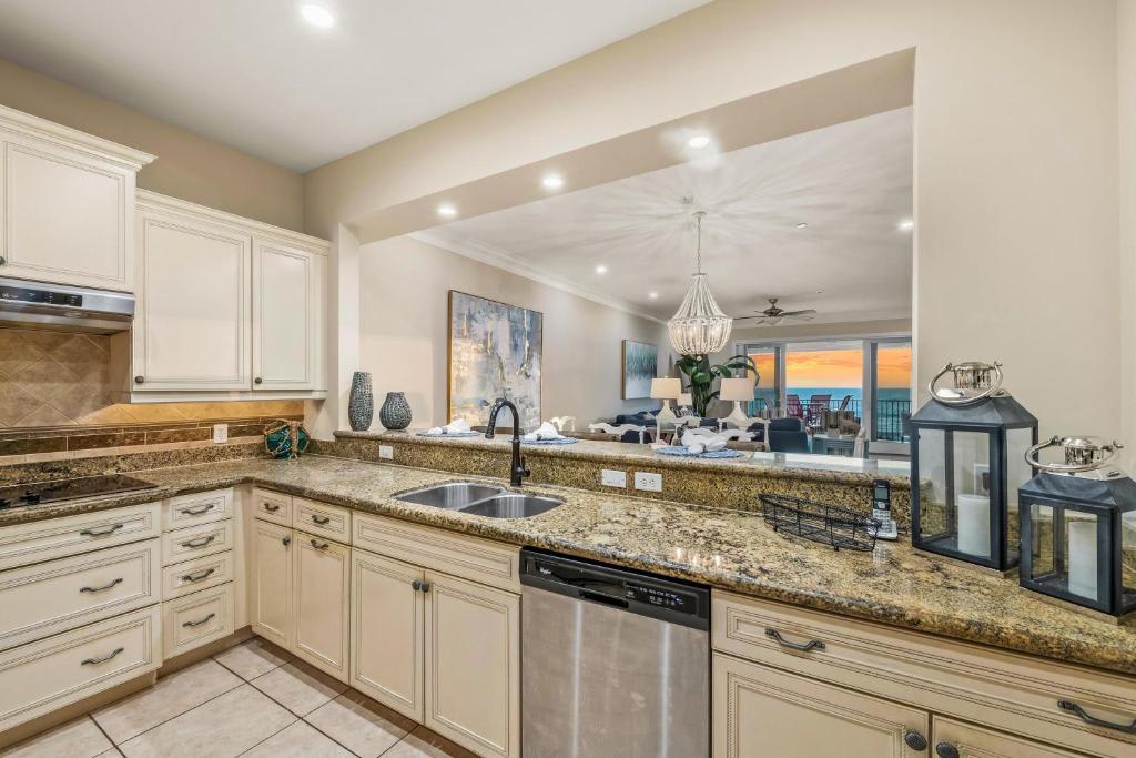 Prepare your favorite meals in this elegant kitchen while soaking in stunning ocean views through the balcony doors—your own slice of coastal paradise.