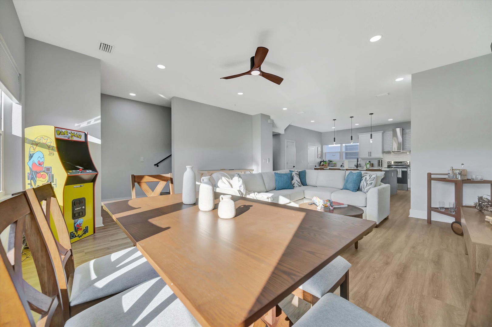 Step into your open-concept haven where light-filled living flows effortlessly. A stylish arcade game awaits, and the modern kitchen invites you to gather, cook, and unwind in contemporary coastal comfort.