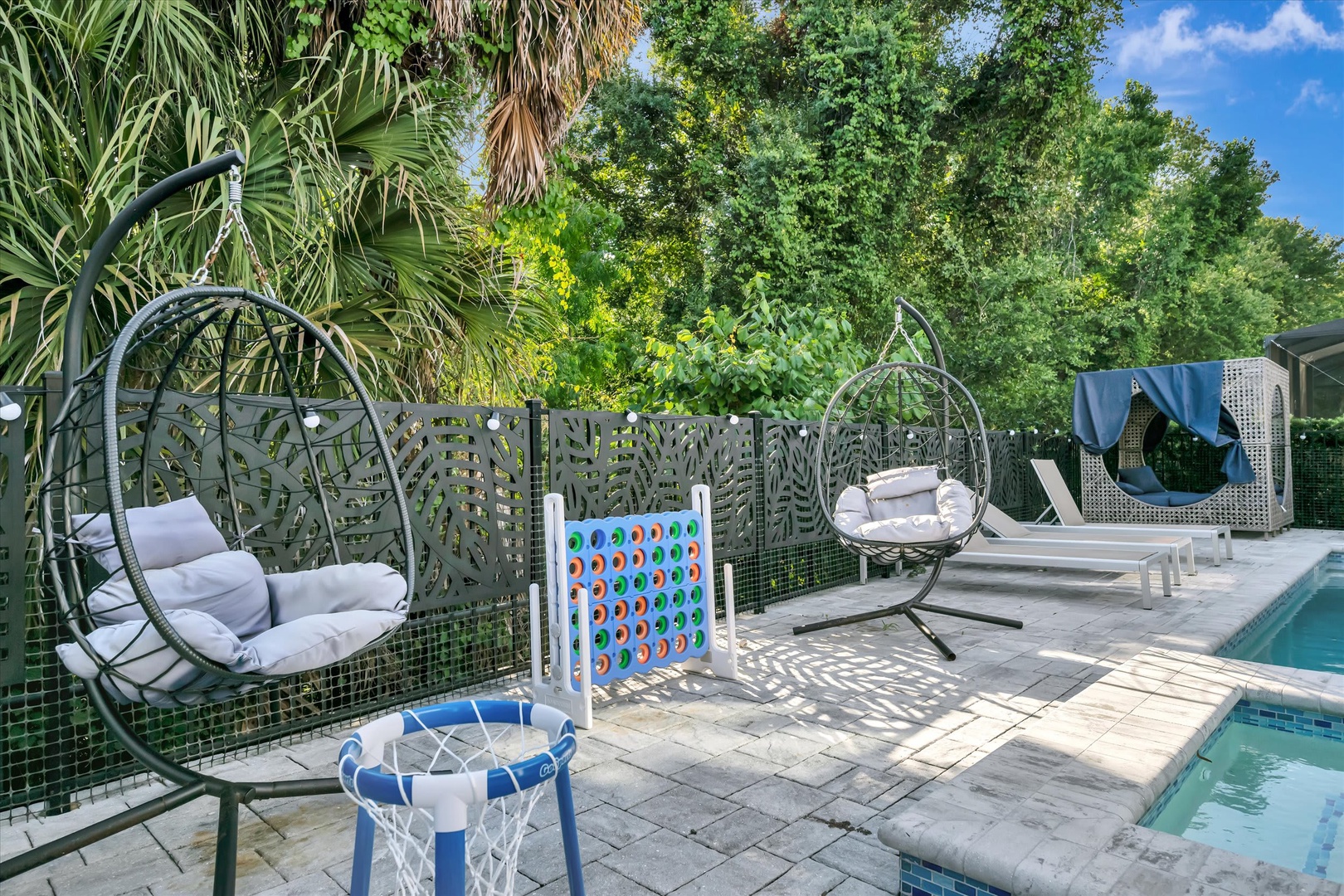 Step into your own private oasis—swing gently in a cozy hanging chair, splash into the sparkling pool, or challenge friends to a game. Lush palms and tropical greenery surround you, creating a tranquil retreat where every moment feels like vacation.