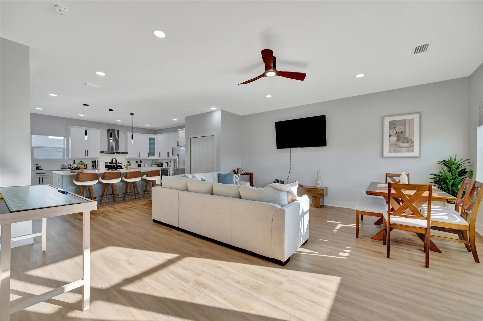 Sunlight streams across your open-concept living space, where modern comfort meets thoughtful design. Gather around the dining table, relax in the lounge, or share stories at the kitchen island—every corner invites connection and ease.