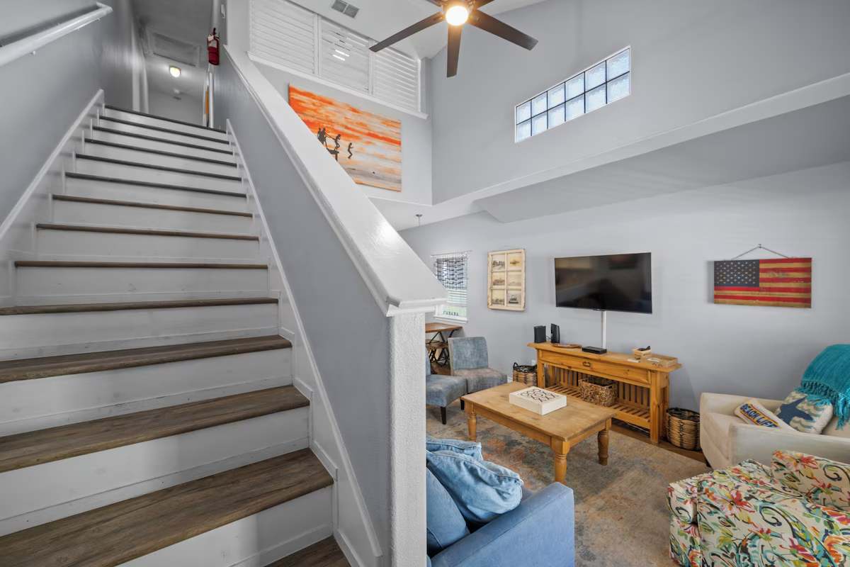 Unwind in your bright, airy living space with soaring vaulted ceilings and coastal charm. The open layout flows effortlessly, inviting you to kick back and feel right at home.