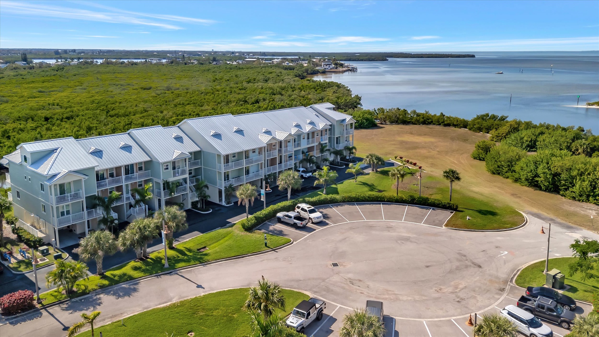 Coastal vacation rentals with lush greenery, waterfront setting, and convenient parking near serene bay views.