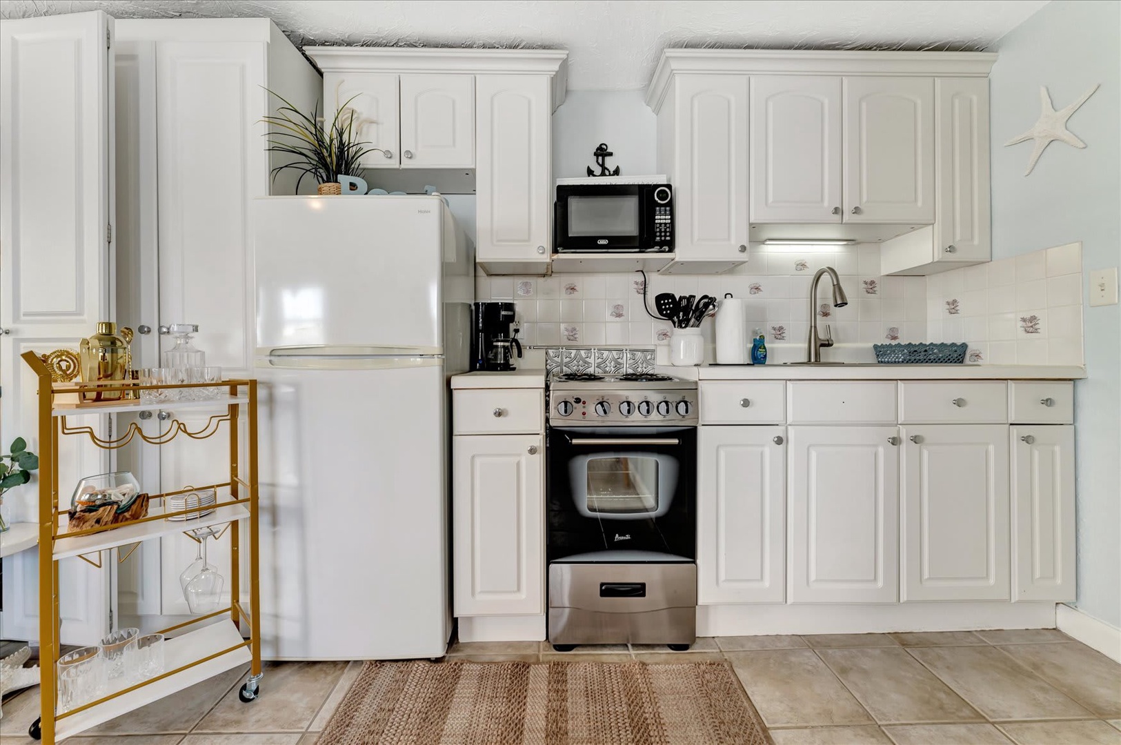 Your fully-equipped kitchen features crisp white cabinets, modern appliances, and all the essentials you need to whip up memorable vacation meals together.