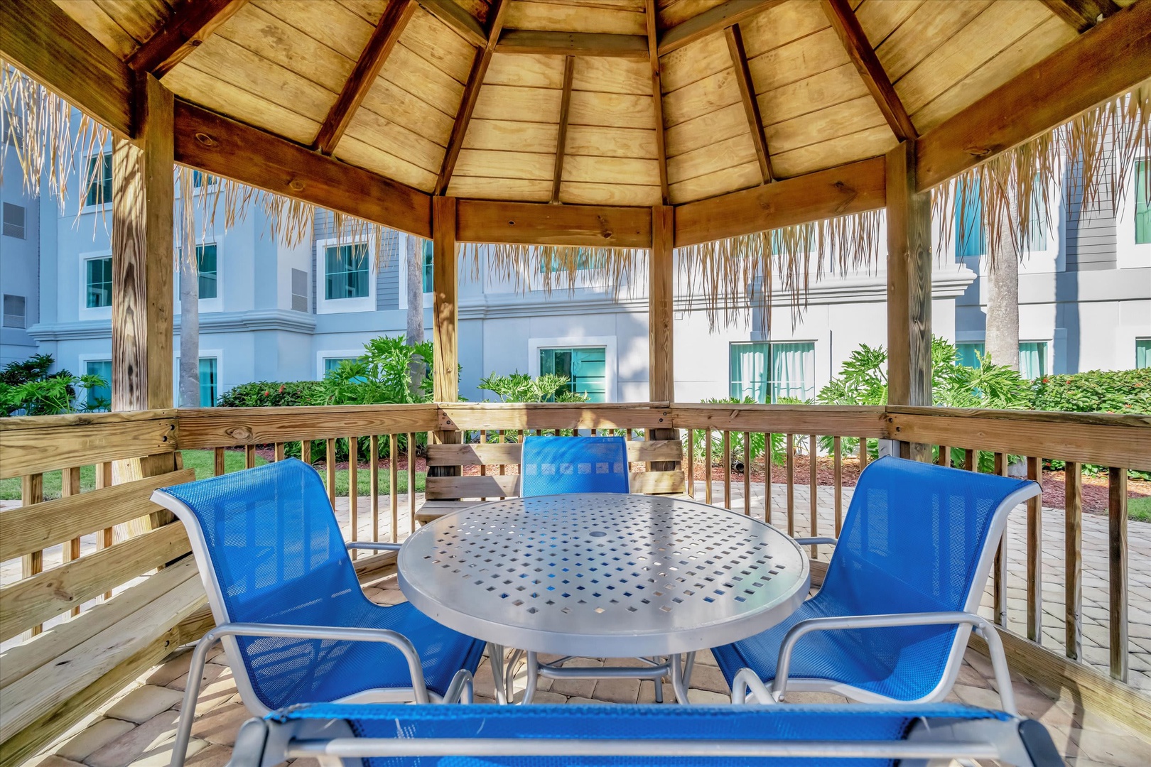Unwind in your private tiki-style cabana with shaded seating and bright tropical touches—your perfect spot to relax between adventures.