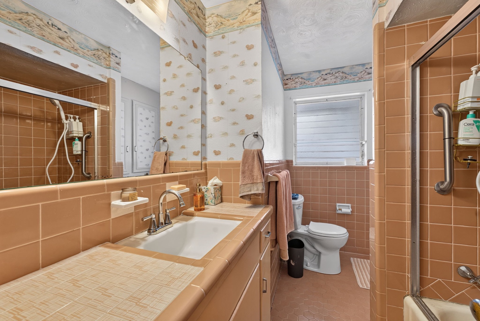Your private bathroom features warm terracotta tile, a vanity with storage, and a spacious walk-in shower—everything you need to feel refreshed after a day of exploring.