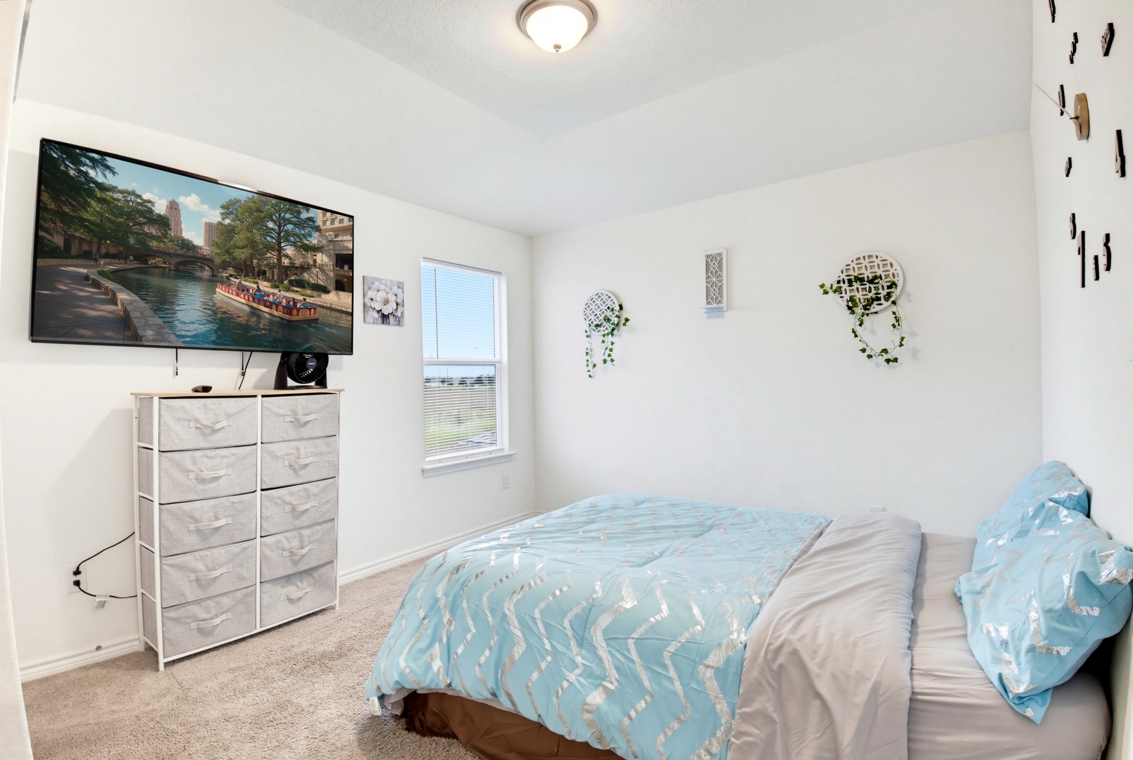 Unwind in your bright, comfy bedroom with a large TV and soft bedding perfect for restful nights.