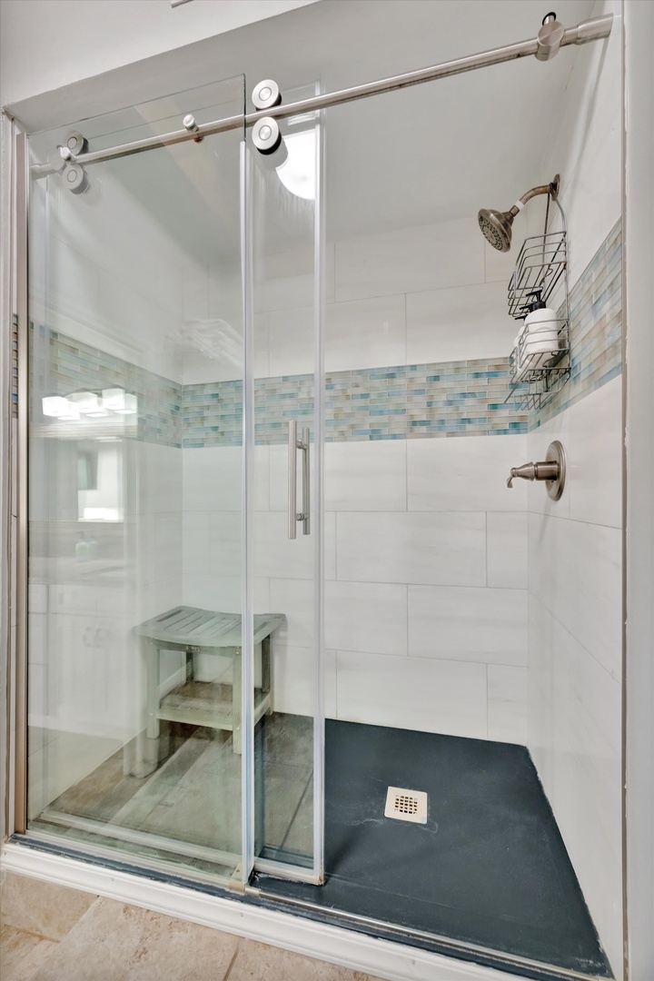 Step into your modern walk-in shower with coastal-inspired tile details and a handy built-in bench—perfect for a refreshing rinse after a day by the beach.