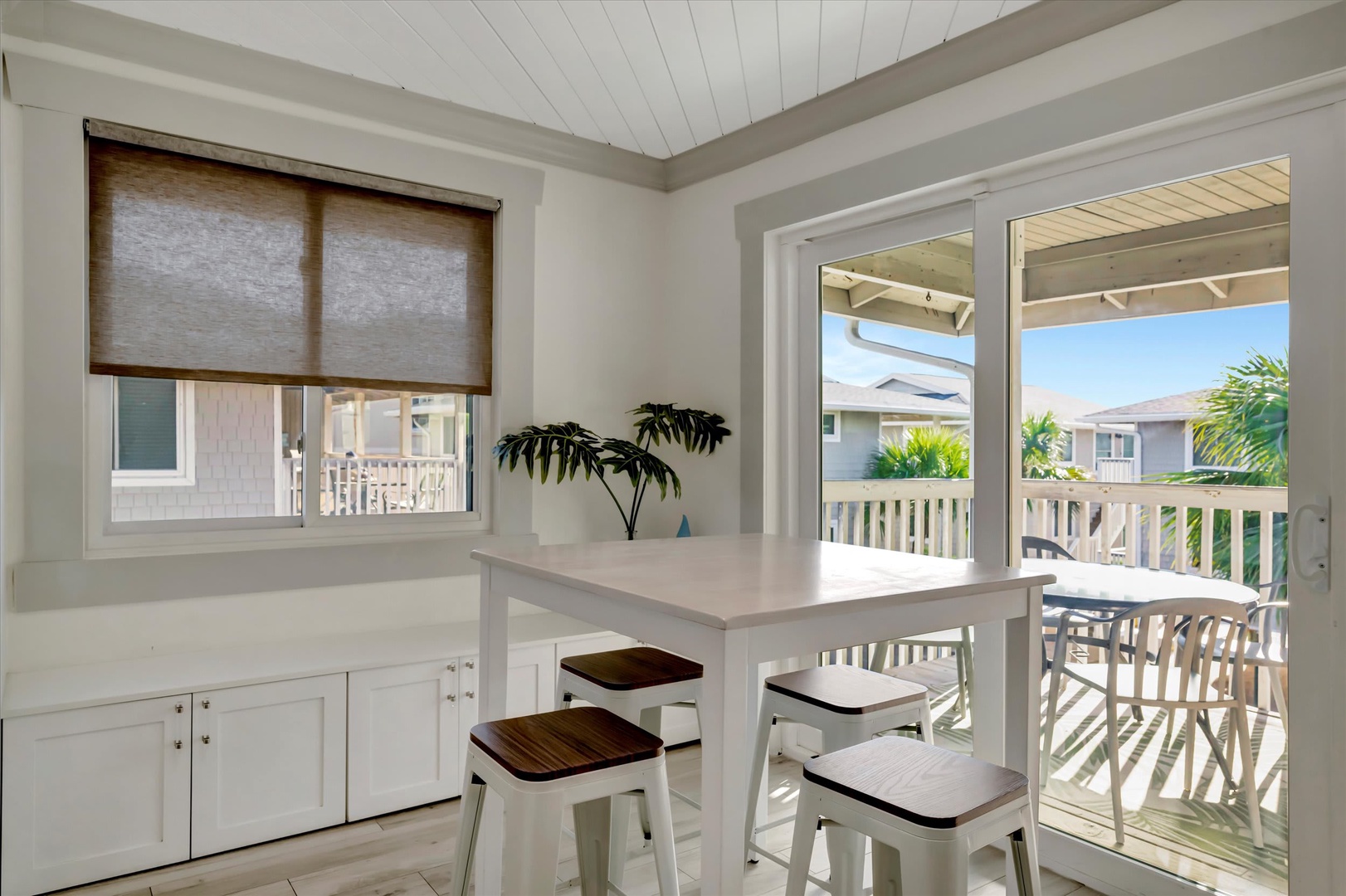 Gather around this bright dining nook where your morning coffee tastes better. Open the doors to let the coastal breeze flow through as you plan your day in paradise.
