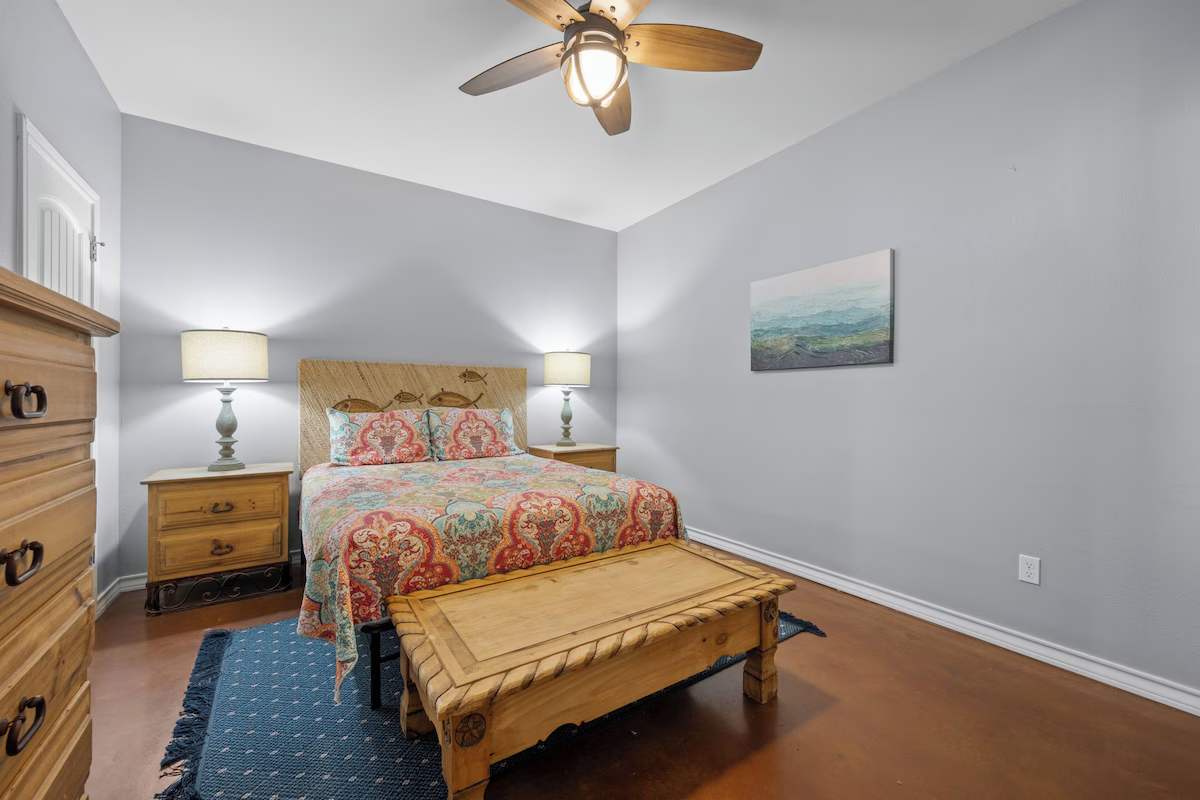 Unwind in your cozy bedroom, where soothing gray tones meet warm wood accents and a plush bed awaits your arrival. Soft lighting creates a peaceful retreat for restful nights.