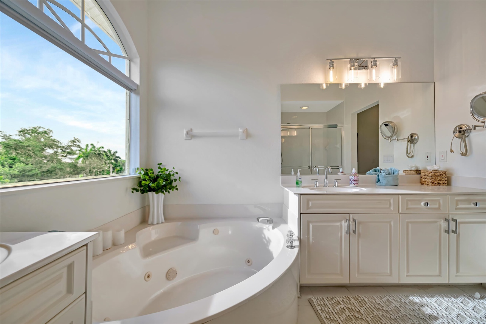 Soak in your own private spa-like retreat. This bright bathroom features a spacious jetted tub and garden views, perfect for unwinding after a day of adventure.