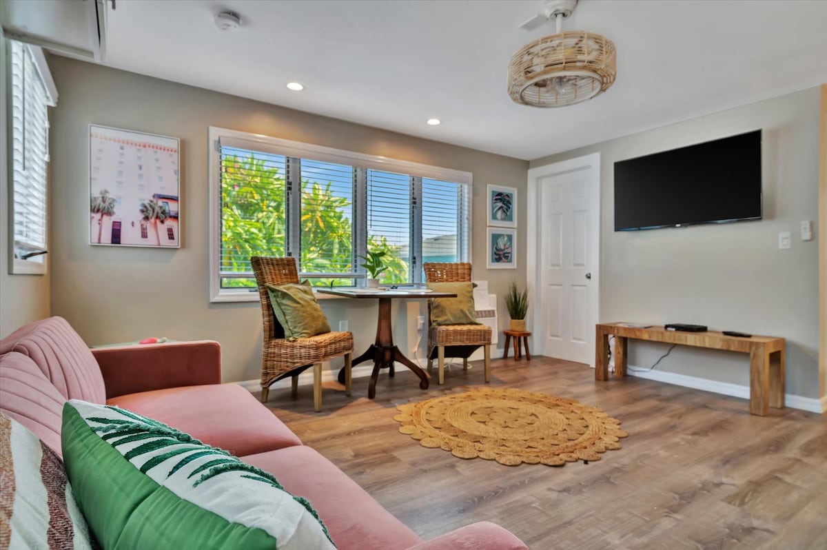 Unwind in your bright, coastal-inspired living space with tropical garden views and modern comforts. The cozy seating and woven accents create the perfect spot to relax after exploring.