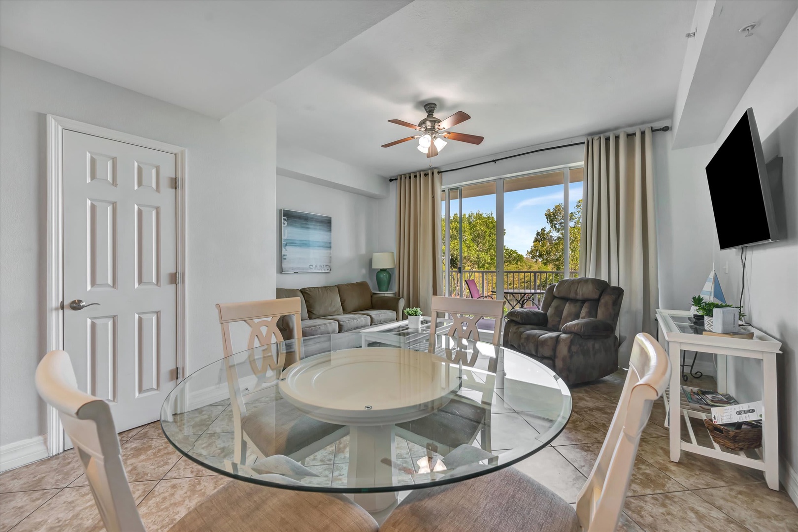 Settle into your inviting living space with plenty of seating, a ceiling fan to keep you cool, and a balcony where you can step outside to soak in the sunshine and leafy views.