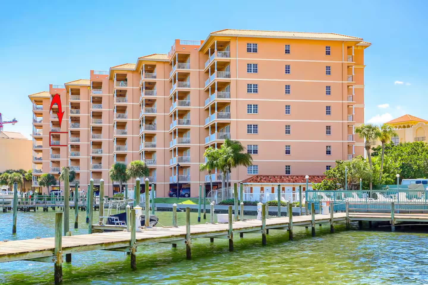 A multi-story beachfront property featuring private dock access and waterfront amenities in a tropical coastal setting.