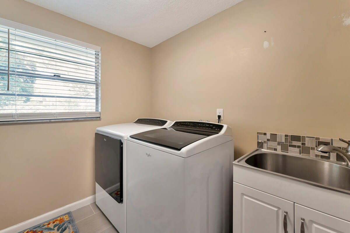 Your dedicated laundry room makes it easy to keep fresh towels and linens ready throughout your stay, with a modern washer, dryer, and convenient utility sink.