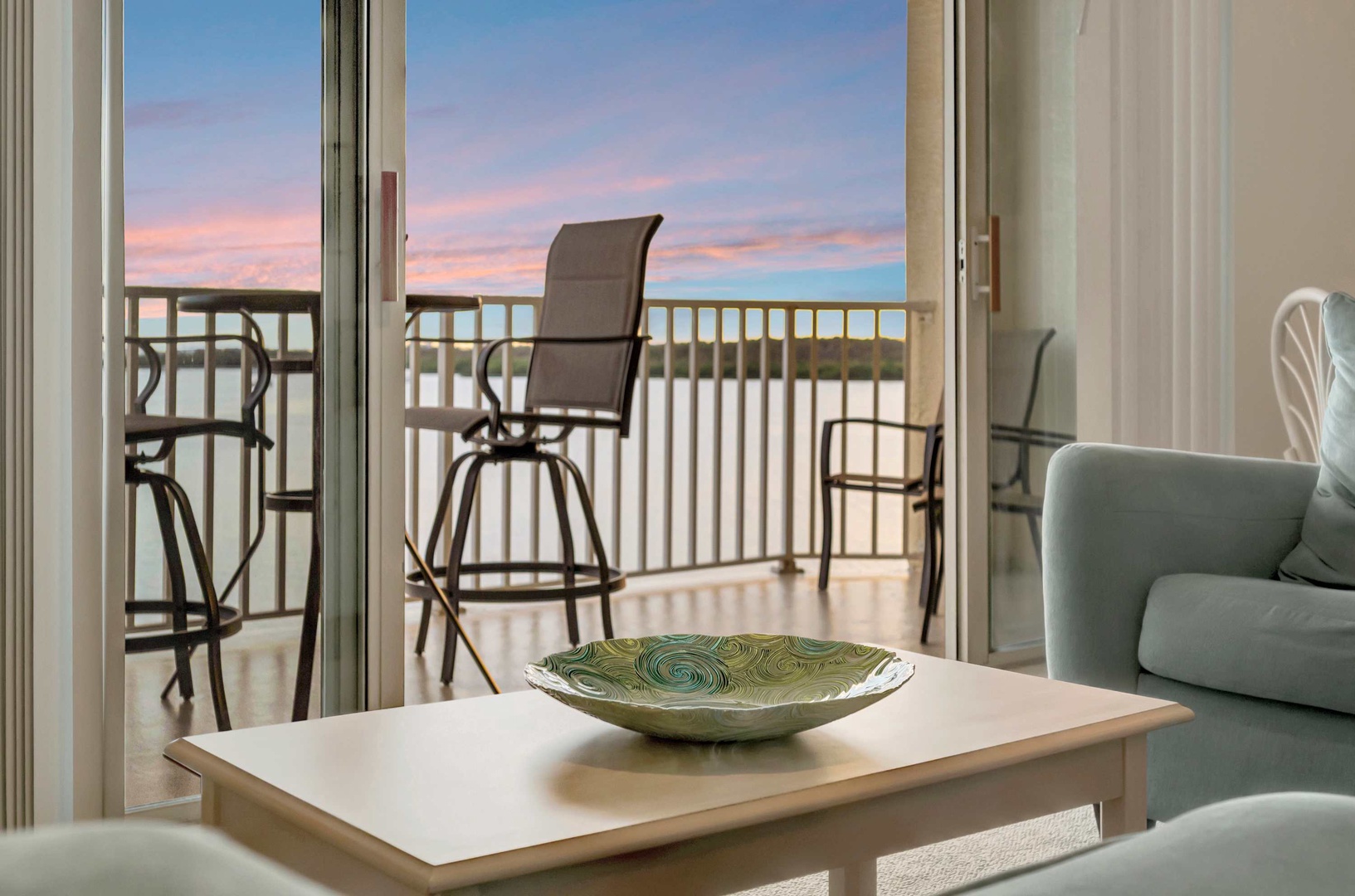Step onto your private balcony and enjoy soft sunset hues painting the sky, with high-top seating perfect for morning coffee or evening cocktails overlooking serene coastal views.