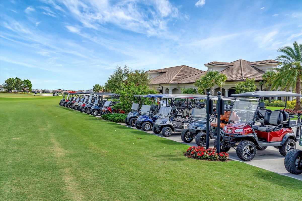 A row of golf carts lined up beside the clubhouse, ready for a day on the green under clear blue skies.