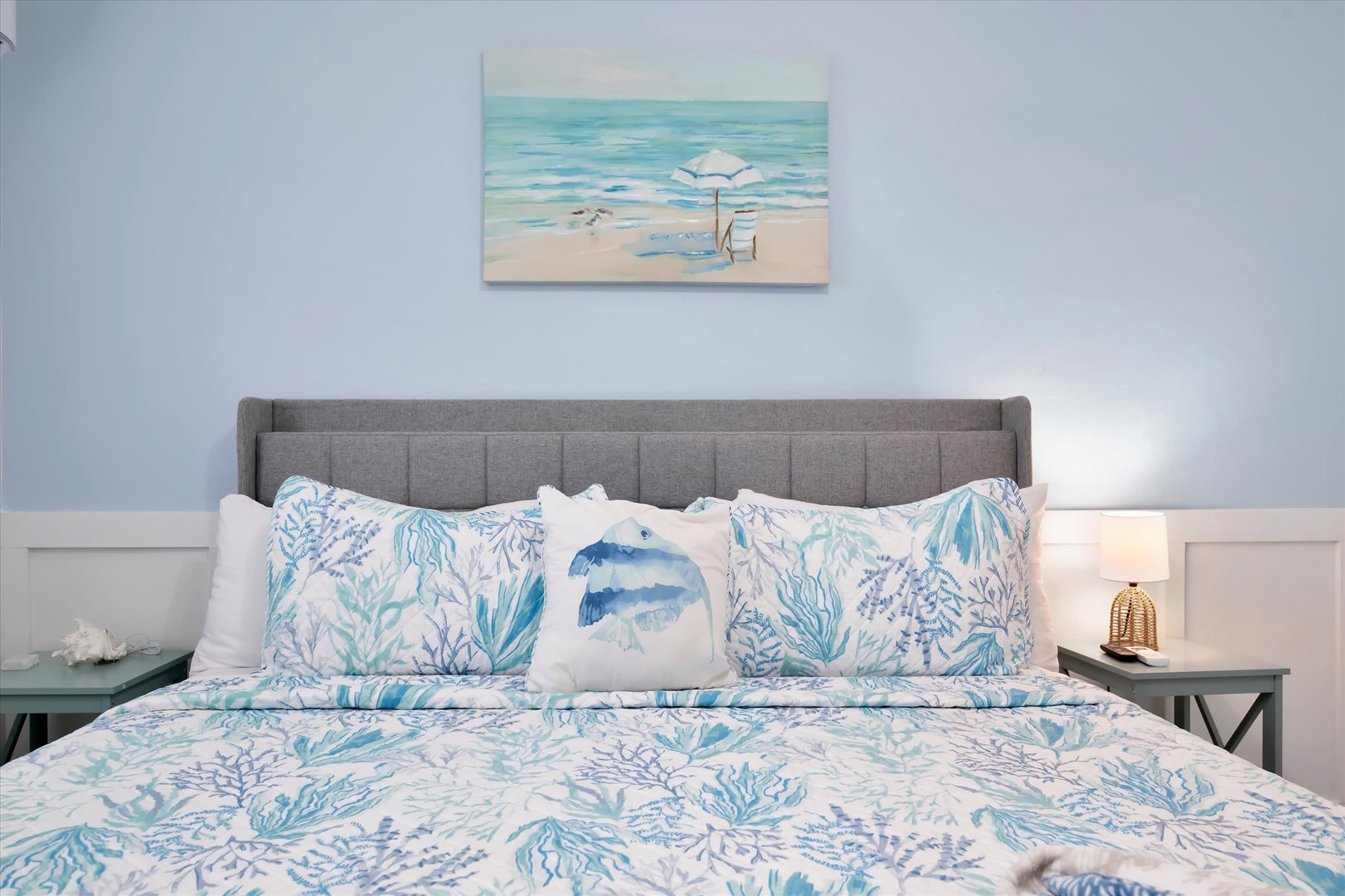 Drift off to sleep in this serene coastal bedroom, where soft blue hues and ocean-inspired accents create a tranquil retreat perfect for your beachside escape.